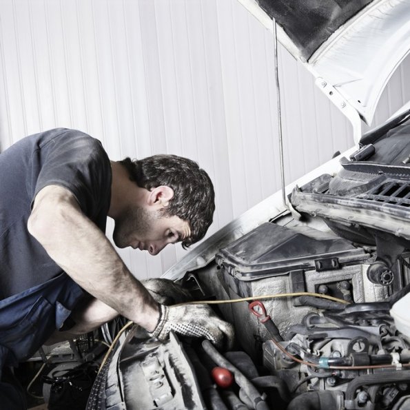 bigstock-auto-mechanic-repairing-a-car--15606254